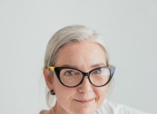 Overcoming Loneliness in Your Golden Years an elderly woman in white shirt wearing eyeglasses