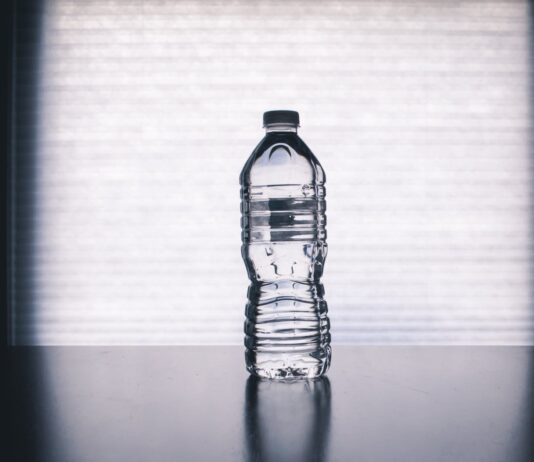 Bottled Water Contains Microplastics. Here’s How to Make It Safe. clear disposable bottle on black surface