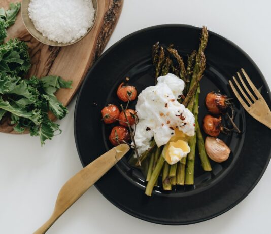 The 7 Keto Side Effects photo of poached egg on top of asparagus