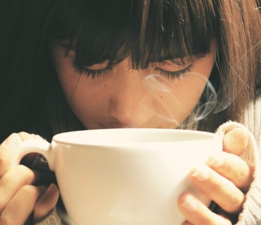 Is Drinking Coffee on an Empty Stomach Harmful? Here’s What Experts Would Like You to Understand woman holding white cup