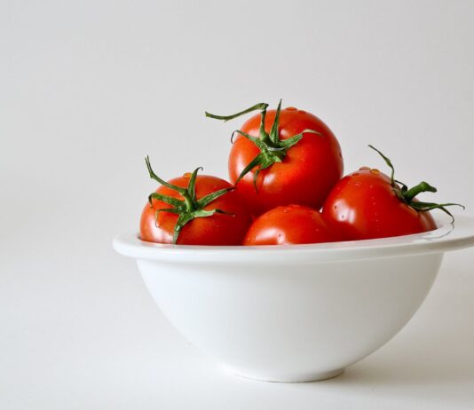 Study Find Eating More Tomatoes Might Help Prevent and Manage High Blood Pressure. red tomatoes in white bowl