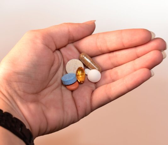 Calcium, Magnesium, and Potassium’s Impact on Blood Pressure Management person holding medication pill and capsules
