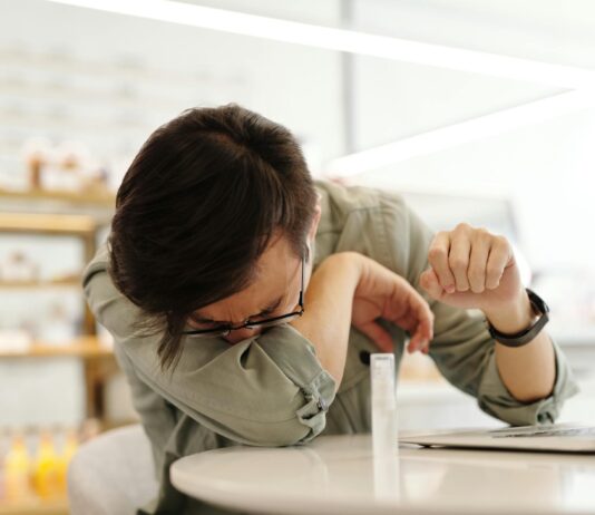 Why Your Spring Allergies May Be Worse This Year a sick man covering his mouth