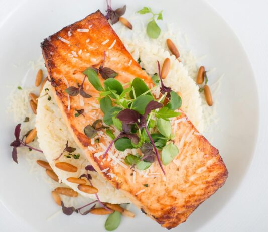 Consuming More Fish Fats and Less Vegetable Oils Can Reduce Migraine Headaches salmon on top of rice